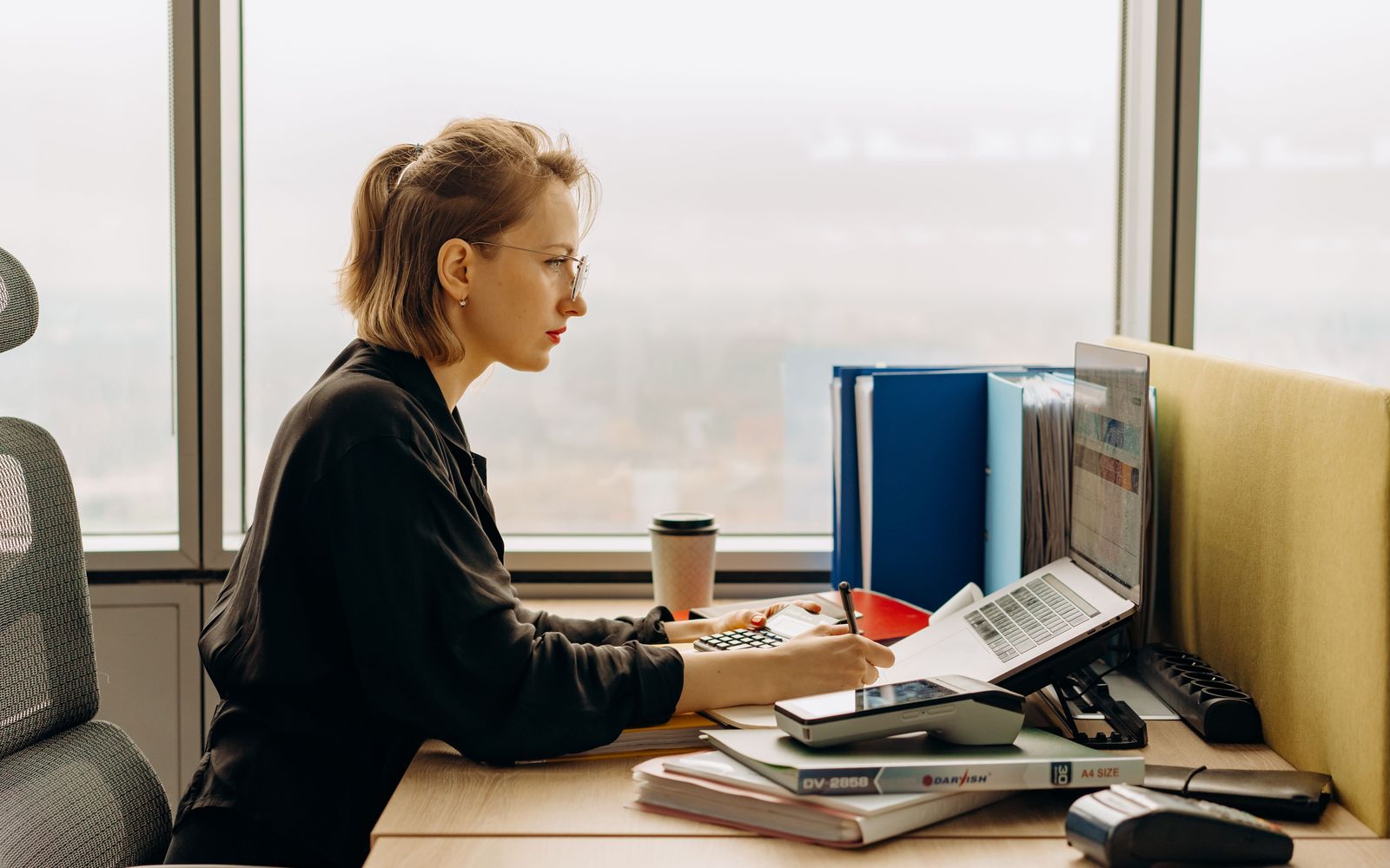 An accountant working on a spreadsheet at an office desk