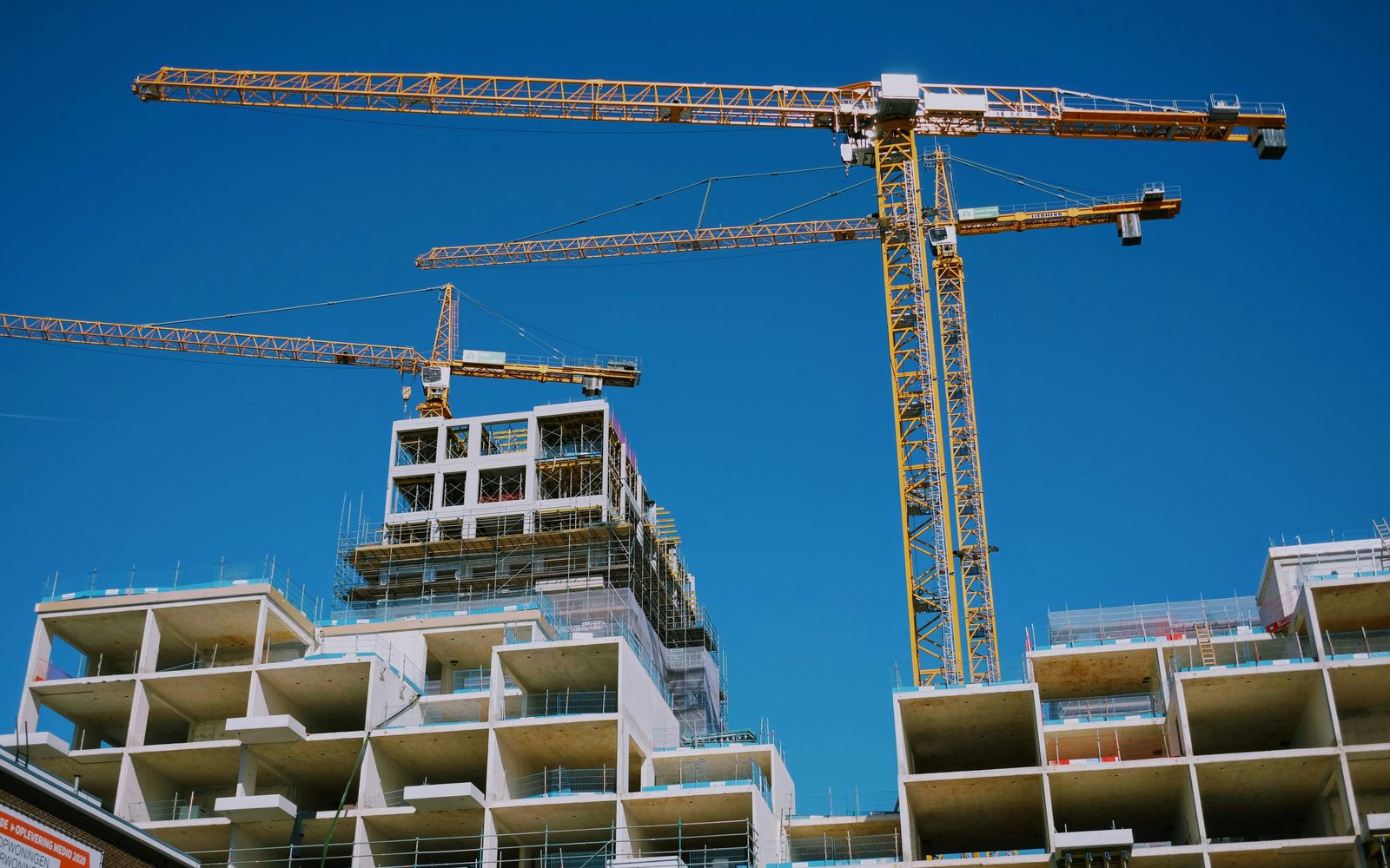 Tower cranes over a residential building under construction
